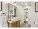 Charming bathroom features a vessel sink, rustic vanity, and decorative black and white patterned tile floor at 5860 Riverwood Dr, Sandy Springs, GA 30328