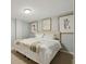 Bedroom with neutral colors, carpet, and comfortable queen sized bed with artwork at 5860 Riverwood Dr, Sandy Springs, GA 30328