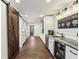 Kitchenette with stainless sink, bar fridge, barn door, and coffee bar at 5860 Riverwood Dr, Sandy Springs, GA 30328
