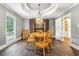 Dining room with hardwood floors, decorative ceiling, light fixture, and window with blinds at 5860 Riverwood Dr, Sandy Springs, GA 30328