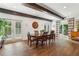 Dining room with hardwood floors, wood beams, french doors, and plantation shutters at 5860 Riverwood Dr, Sandy Springs, GA 30328