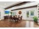 Dining room with wood beams, hardwood floors, and access to the pool area at 5860 Riverwood Dr, Sandy Springs, GA 30328