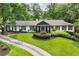 Charming ranch-style home with a beautifully landscaped front yard and circular driveway at 5860 Riverwood Dr, Sandy Springs, GA 30328