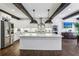 Bright, updated kitchen featuring a large island, stainless appliances, hardwood floors, and wood beam accents at 5860 Riverwood Dr, Sandy Springs, GA 30328