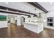 Open kitchen with large island, stainless appliances, white cabinets, hardwood floors, and pendant lighting at 5860 Riverwood Dr, Sandy Springs, GA 30328