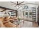 Inviting living room with large windows, exposed beams, and view to a pool area at 5860 Riverwood Dr, Sandy Springs, GA 30328
