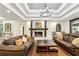 Cozy living room featuring a stone fireplace, dark wood beams, and stylish decor at 5860 Riverwood Dr, Sandy Springs, GA 30328