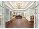 Elegant living room with hardwood floors, tray ceilings, and an open view to the backyard at 5860 Riverwood Dr, Sandy Springs, GA 30328