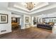 Open-concept living room with hardwood floors, fireplace, and views to dining and sitting area at 5860 Riverwood Dr, Sandy Springs, GA 30328