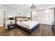 Spacious main bedroom features a king bed, hardwood floors, and a wall of custom built in cabinets at 5860 Riverwood Dr, Sandy Springs, GA 30328