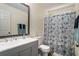 Bathroom with a shower-tub combination, modern vanity, and a framed mirror at 855 Lakeside Cir, Covington, GA 30016