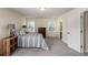 Bright bedroom with neutral carpet, two windows, and classic wooden furniture at 855 Lakeside Cir, Covington, GA 30016