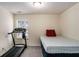 Spare bedroom with a small window featuring exercise equipment and a bed at 855 Lakeside Cir, Covington, GA 30016
