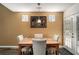 Cozy dining area featuring a wooden table with seating for four and stylish wall decor at 855 Lakeside Cir, Covington, GA 30016