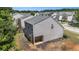 Rear exterior view of a two-story home with neutral siding and a covered porch area at 855 Lakeside Cir, Covington, GA 30016