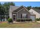 Cozy home featuring stone accents around the front door, and a well-manicured lawn at 855 Lakeside Cir, Covington, GA 30016