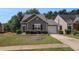Charming one-story home with stone accents, well-maintained lawn, and attached garage at 855 Lakeside Cir, Covington, GA 30016