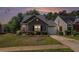 Charming one-story home with stone accents, well-maintained lawn, and attached garage at 855 Lakeside Cir, Covington, GA 30016
