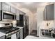 Modern kitchen with stainless steel appliances, gas range, and stylish gray cabinets at 855 Lakeside Cir, Covington, GA 30016