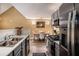 Updated kitchen with stainless steel appliances, gray cabinets, and adjacent dining area at 855 Lakeside Cir, Covington, GA 30016