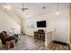 Inviting living room with natural light, fan, wood-look floors, staircase, and front door at 855 Lakeside Cir, Covington, GA 30016