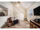Cozy living room with high ceiling, fan, wood-look floors, and staircase to upper level at 855 Lakeside Cir, Covington, GA 30016