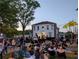 Outdoor community event on the lawn in front of a large building with music and attendees enjoying a night out at 132 Olympic Pl, Decatur, GA 30030