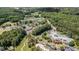Expansive aerial view showcasing community amenities including a pool, tennis courts, and golf course at 402 Lake Point Trce, Canton, GA 30114