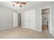 Cozy bedroom with neutral walls, plush carpet, ceiling fan, and easy access to bathroom at 402 Lake Point Trce, Canton, GA 30114