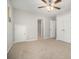 Spacious bedroom featuring plush carpet, ceiling fan, closet, and easy access to bathroom at 402 Lake Point Trce, Canton, GA 30114