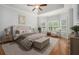 Serene bedroom with a plush bed, bay windows, and hardwood floors at 402 Lake Point Trce, Canton, GA 30114