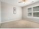 Inviting bedroom with neutral walls, plush carpet, windows with blinds, and a modern ceiling fan at 402 Lake Point Trce, Canton, GA 30114