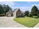 Beautiful two-story brick home boasting a spacious driveway and manicured lawn with professional landscaping at 402 Lake Point Trce, Canton, GA 30114