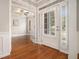 Bright foyer featuring hardwood floors, white trim, and a front door with sidelights at 402 Lake Point Trce, Canton, GA 30114