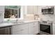Modern kitchen with stainless steel appliances, white cabinets, stylish backsplash, and natural lighting at 402 Lake Point Trce, Canton, GA 30114