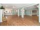 Spacious living room featuring wood floors, stylish decor, and open layout, with view into kitchen at 402 Lake Point Trce, Canton, GA 30114