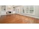 Cozy living room featuring a fireplace, built-in shelving, and large windows with views of the backyard at 402 Lake Point Trce, Canton, GA 30114