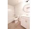 Bathroom with a shower-tub combo, toilet, vanity with sink, and modern round mirror at 4305 Huron Dr, Cumming, GA 30028