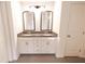 Bathroom featuring double sink vanity with granite countertop and shaker cabinets, providing style and functionality at 4305 Huron Dr, Cumming, GA 30028