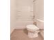 Well-lit bathroom featuring a shower-tub, toilet, and tiled floor at 4305 Huron Dr, Cumming, GA 30028