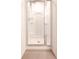 Modern bathroom shower with clear glass door, stainless steel fixtures, and built-in shelving at 4305 Huron Dr, Cumming, GA 30028