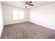 Spacious bedroom featuring carpeting, a ceiling fan, and natural light from the window at 4305 Huron Dr, Cumming, GA 30028