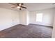 Comfortable bedroom with neutral carpet, ceiling fan, and a window enhancing the bright ambiance at 4305 Huron Dr, Cumming, GA 30028