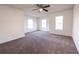Bright bedroom featuring neutral carpeting, ceiling fan, and windows that provide natural light at 4305 Huron Dr, Cumming, GA 30028