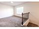Spacious bedroom or flex room with a neutral carpet, a window for natural light and staircase access at 4305 Huron Dr, Cumming, GA 30028