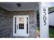A welcoming front door with glass panes and sidelights enhances the curb appeal of this brick home at 4305 Huron Dr, Cumming, GA 30028