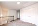 Bright second floor hallway with neutral carpet and access to multiple rooms, providing a versatile living space at 4305 Huron Dr, Cumming, GA 30028