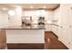 Bright kitchen featuring white cabinetry, granite countertops, stainless steel appliances, and hardwood floors at 4305 Huron Dr, Cumming, GA 30028