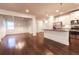 Open concept kitchen and dining with hardwood floors, pendant lights, and stainless steel appliances at 4305 Huron Dr, Cumming, GA 30028