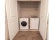 Convenient laundry area with modern washer and dryer, accessible through white double doors at 4305 Huron Dr, Cumming, GA 30028